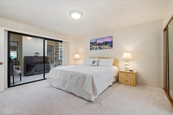 a bedroom with a bed and a lamp