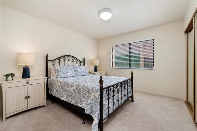 a bedroom with a bed and a table