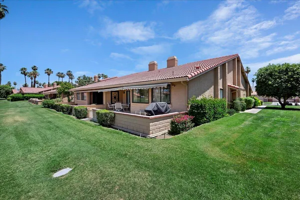 a view of house with a yard