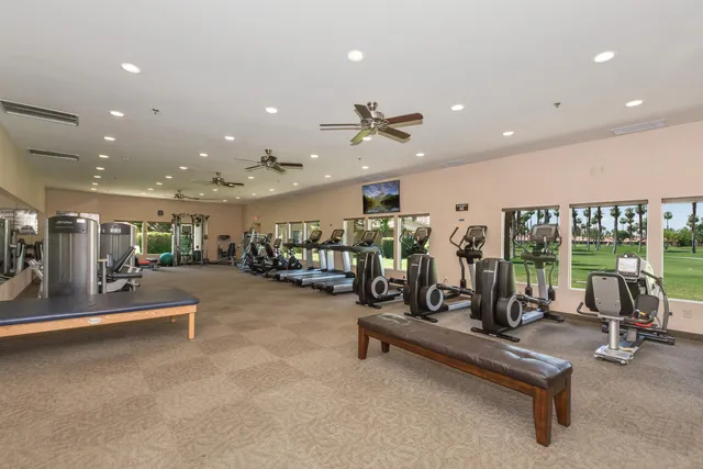 a view of a room with gym equipment and a large window