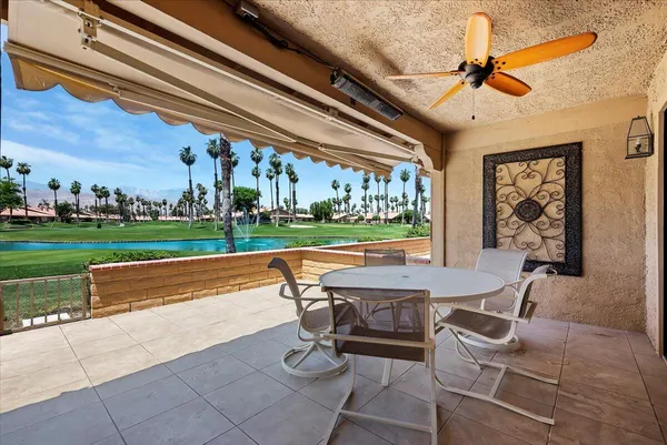 a view of a patio with a dining table and chairs
