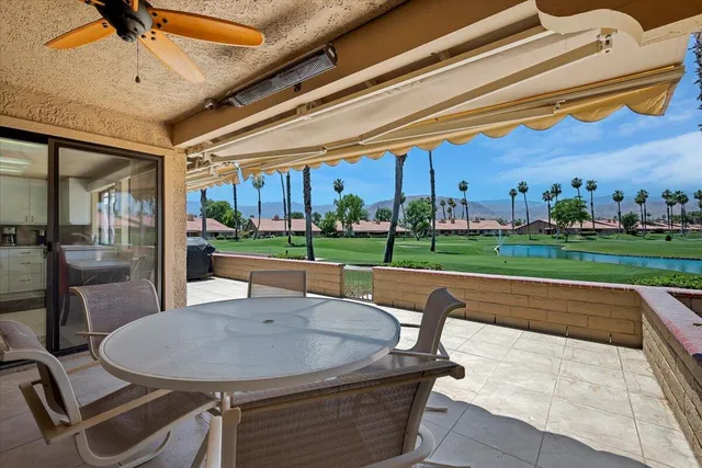 a view of a patio with a table and chairs