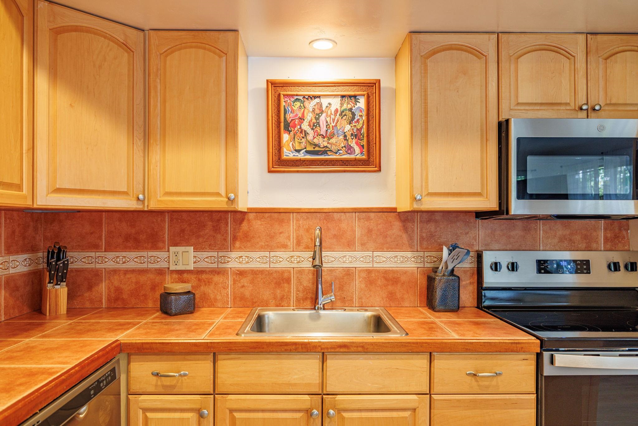 3559 Lower Honoapiilani Road, Unit 720 Lahaina, HI 96761 - Photo 12 of 31 a kitchen with a sink and cabinets