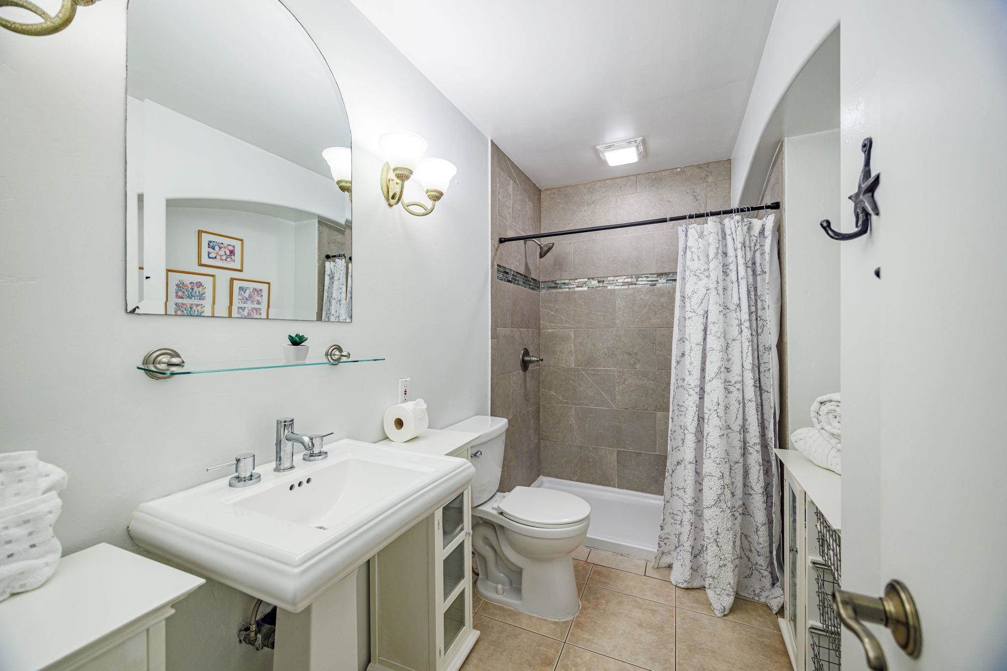 3559 Lower Honoapiilani Road, Unit 720 Lahaina, HI 96761 - Photo 22 of 31 a bathroom with a sink toilet and shower