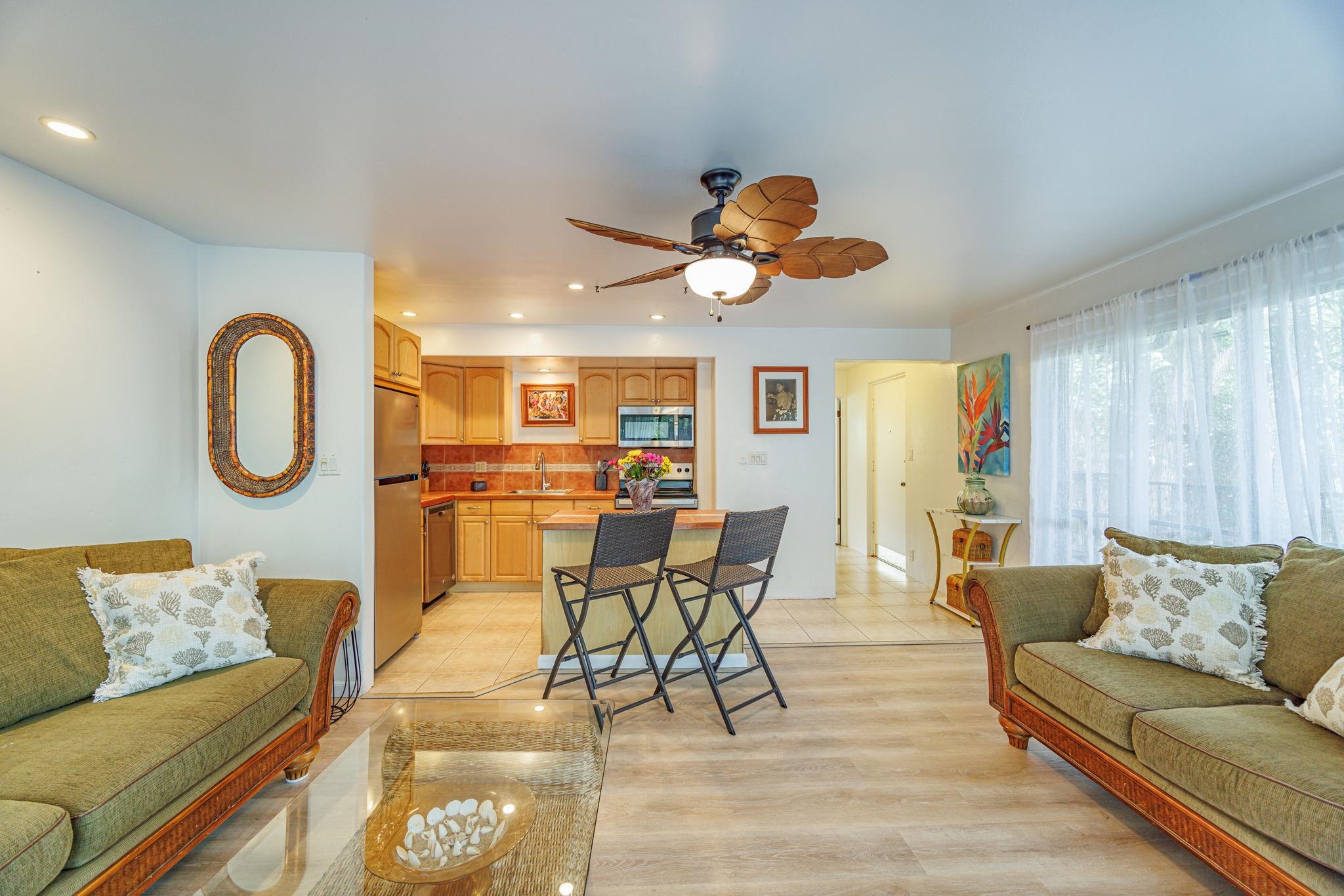 3559 Lower Honoapiilani Road, Unit 720 Lahaina, HI 96761 - Photo 7 of 31 a living room with furniture kitchen view and a large window
