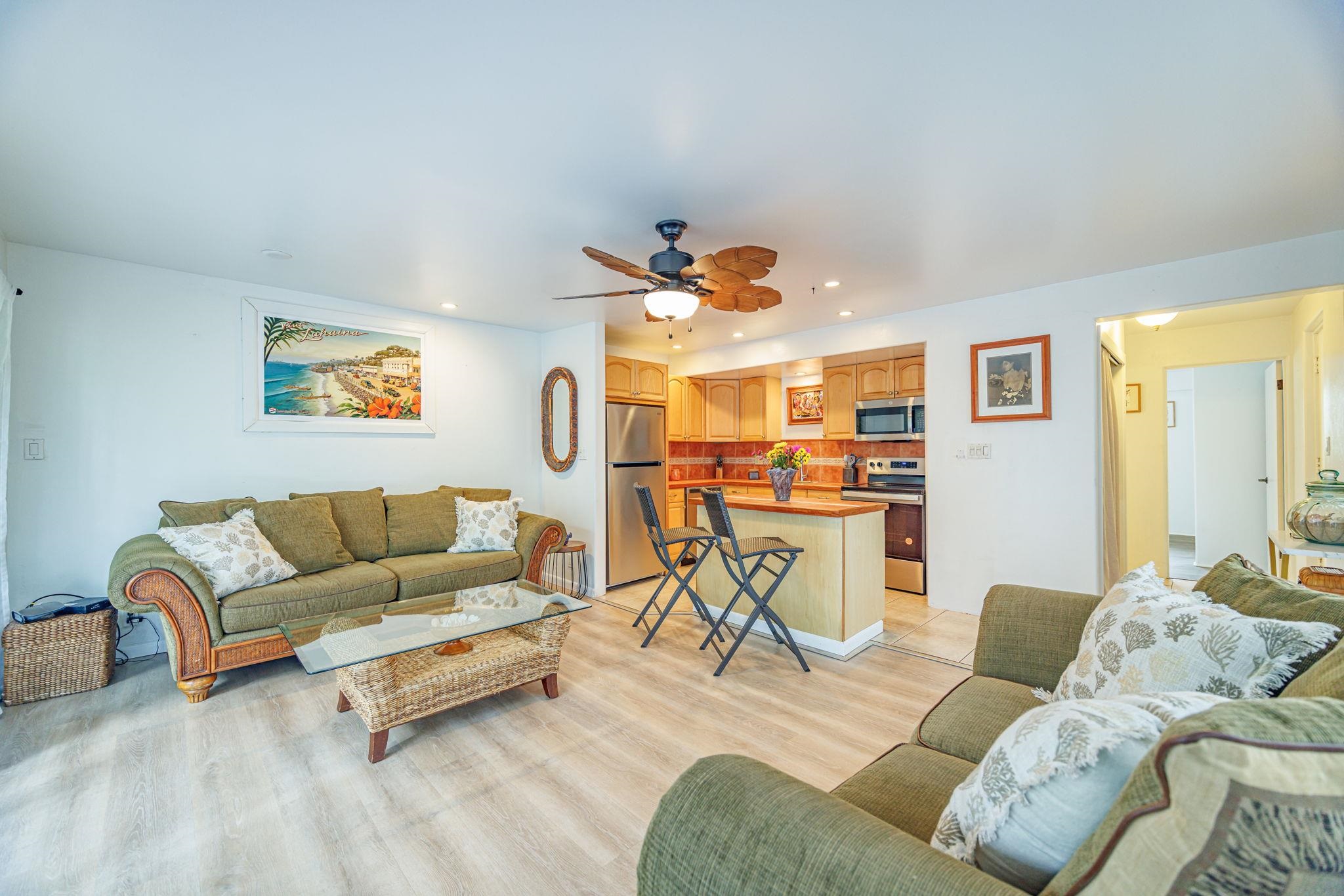 3559 Lower Honoapiilani Road, Unit 720 Lahaina, HI 96761 - Photo 9 of 31 a living room with furniture and kitchen view