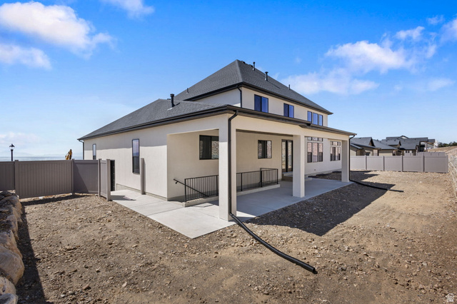 692 East Mountain Road North Ogden, UT 84414 - Photo 17 of 17 Contemporary stucco exterior with a covered patio featuring a concrete slab and black railing
