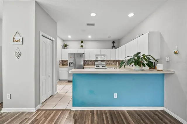 a kitchen with stainless steel appliances a refrigerator sink and cabinets
