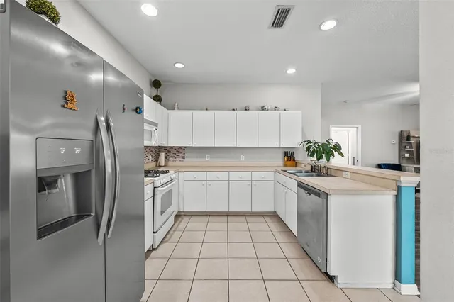 a kitchen with a sink stainless steel appliances and cabinets