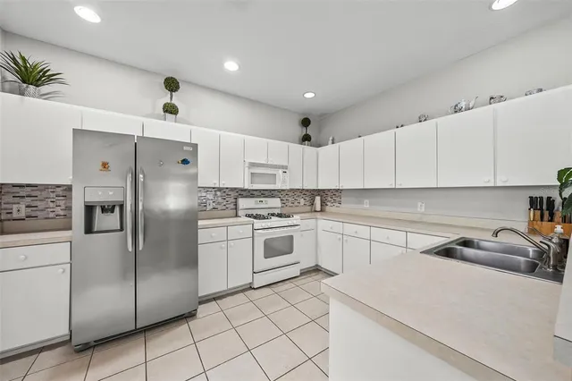 a kitchen with cabinets and stainless steel appliances