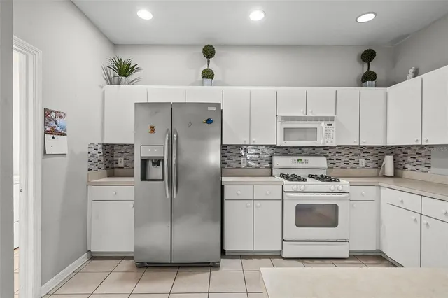 a kitchen with stainless steel appliances cabinets a sink and a counter top space