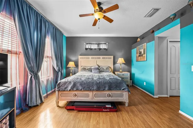 a bedroom with a bed and a chandelier