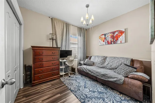 a living room with furniture and a chandelier