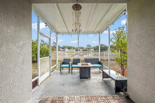 a room with furniture and a floor to ceiling window