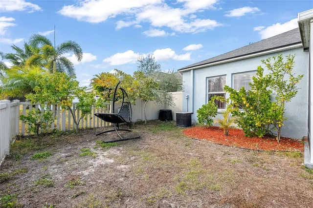 a view of a backyard with plants and a patio