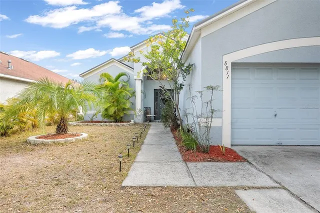 a view of a pathway along the house