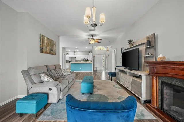 a living room with fireplace furniture and a flat screen tv