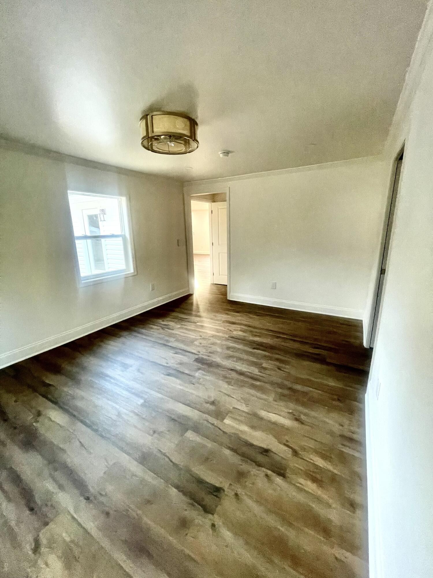 721 South Jackson Street Athens, TN 37303 - Photo 17 of 17 an empty room with wooden floor and windows