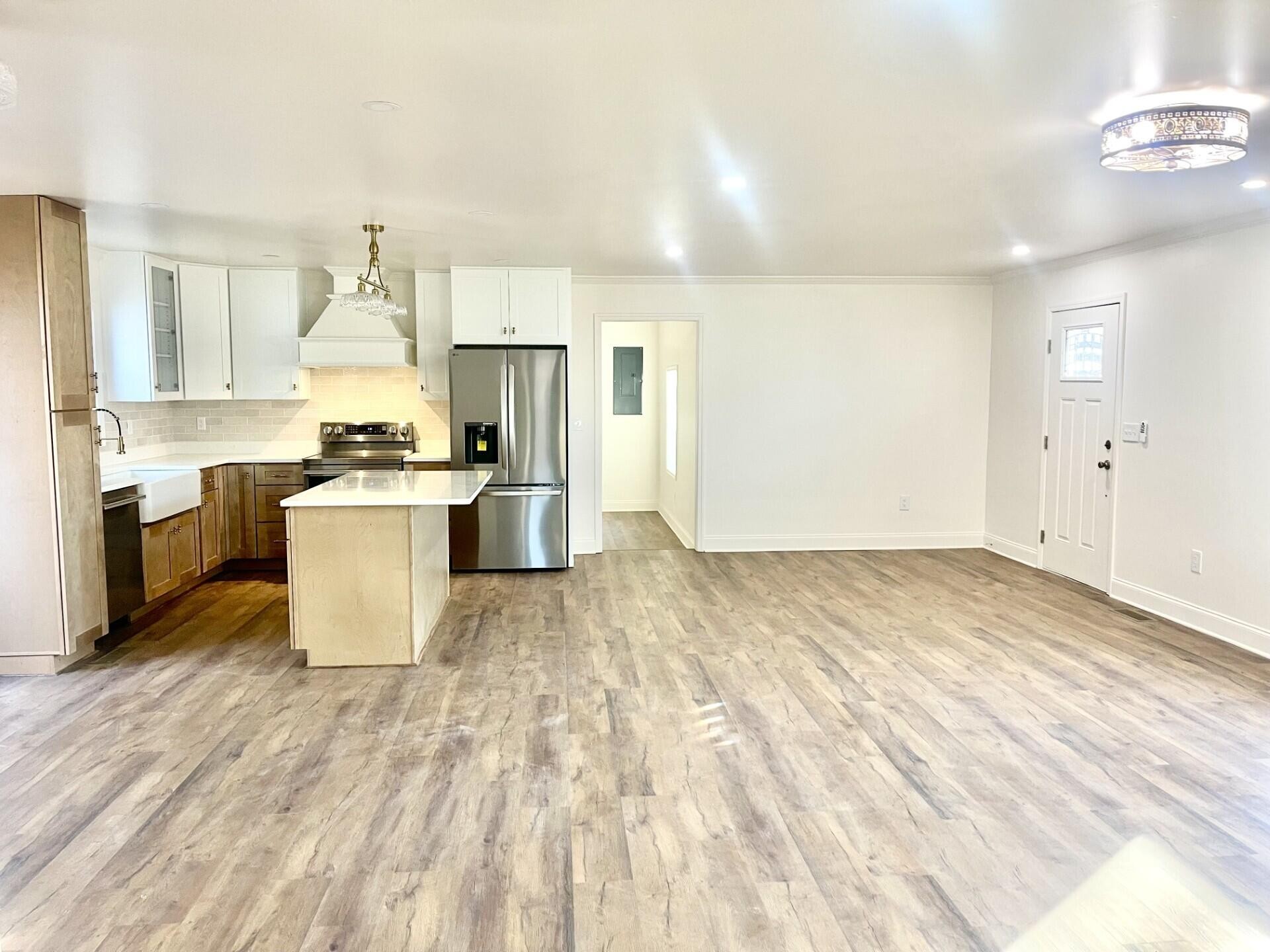 721 South Jackson Street Athens, TN 37303 - Photo 9 of 17 a large white kitchen with a stove a sink dishwasher and a refrigerator with wooden floor