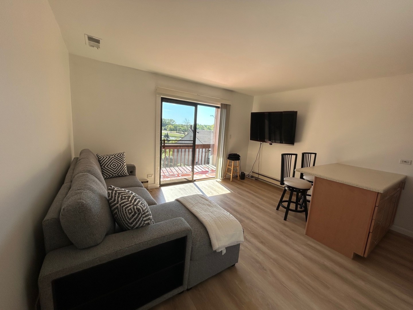 58 Vail Colony, Unit 10 Fox Lake, IL 60020 - Photo 2 of 7 a bedroom with a bed and a flat screen tv