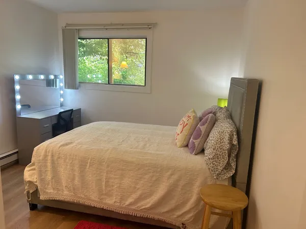 a bedroom with a bed and window