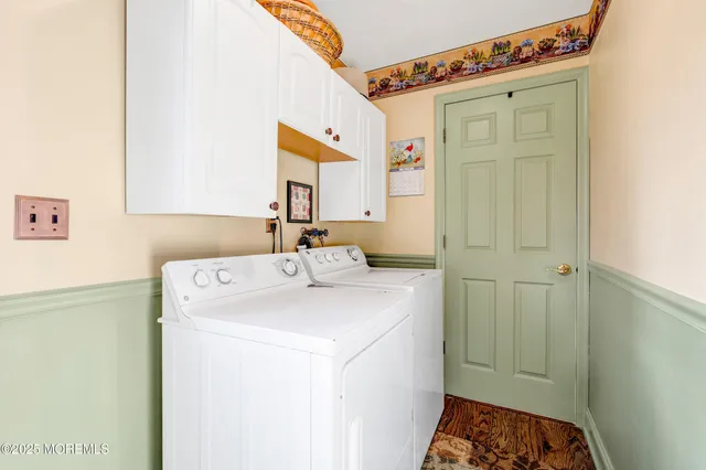 a view of a dining room with furniture a chandelier and wooden floor
