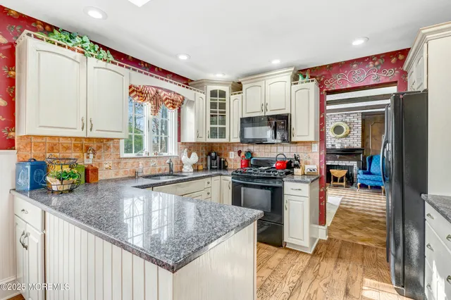 a kitchen with a sink cabinets and window