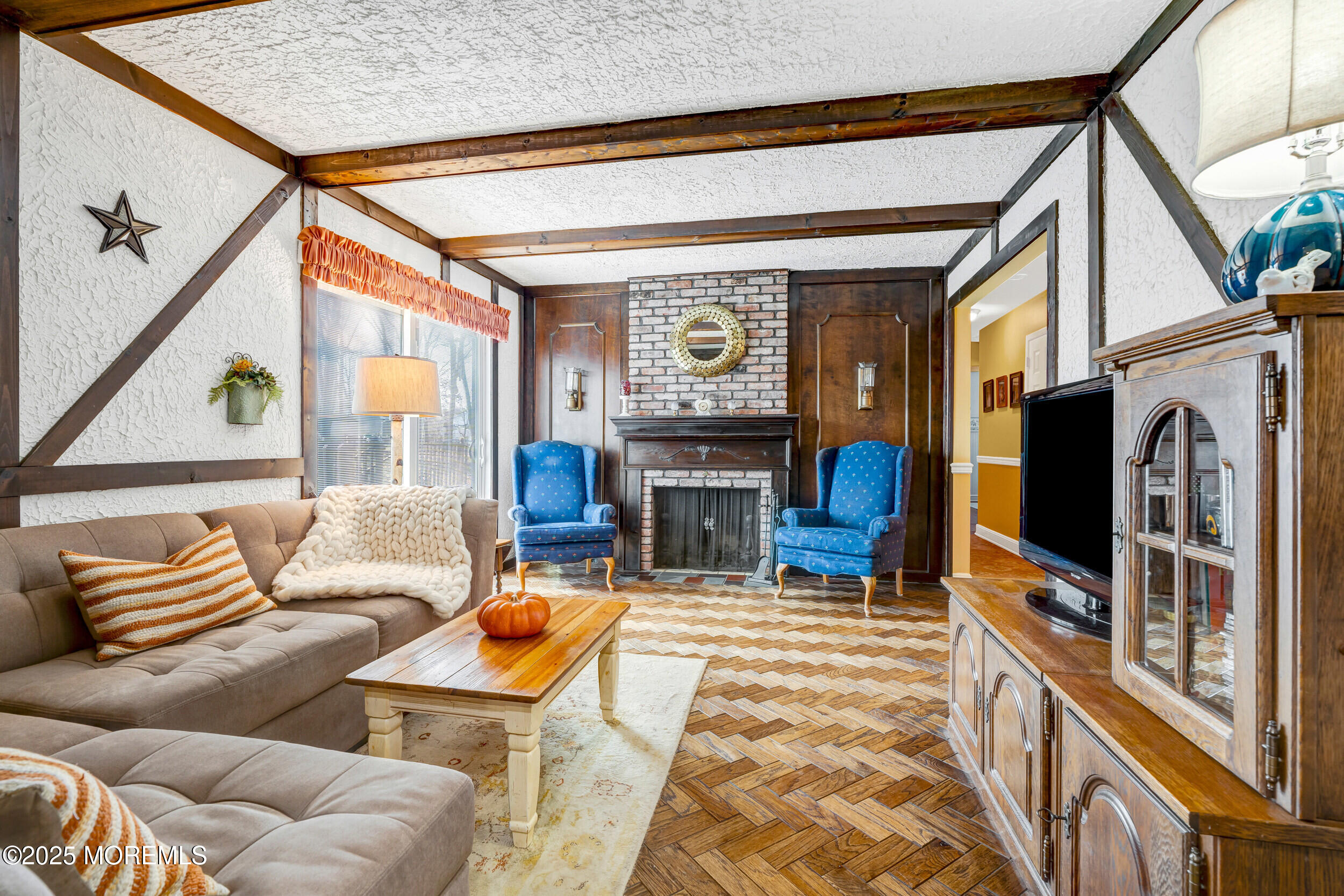 21 Meadowbrook Drive Howell, NJ 07731 - Photo 32 of 52 a living room with furniture a flat screen tv and a fireplace