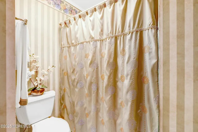 a view of a bedroom with baby crib and cabinet