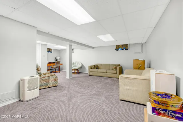 a view of a big house with a big yard and large tree