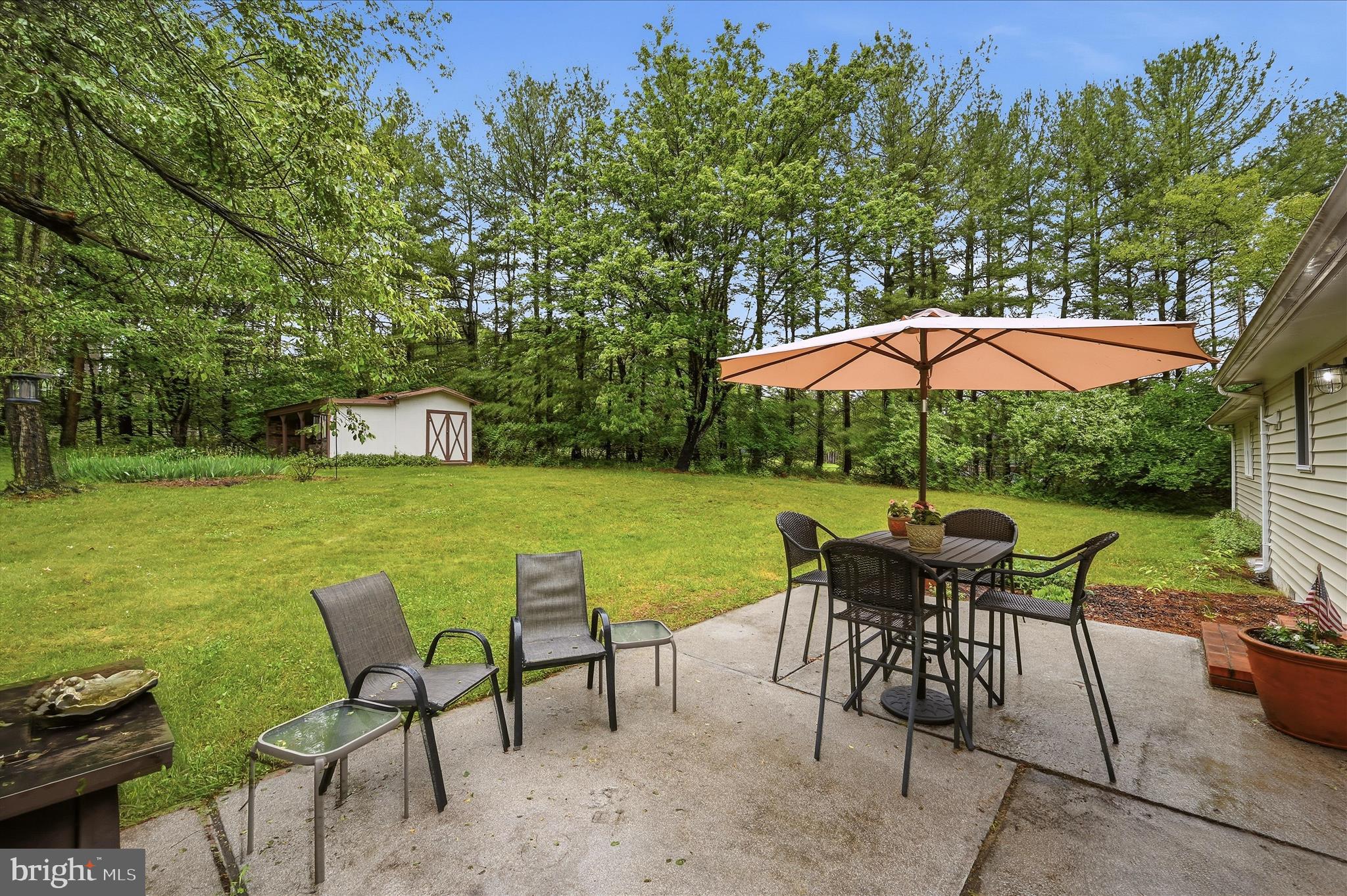 244 High Banks Road Stephenson, VA 22656 - Photo 32 of 45 a view of patio with table and chairs under an umbrella