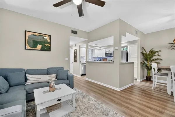 a living room with furniture and kitchen view