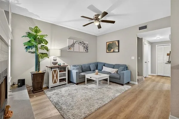 a living room with furniture and a potted plant
