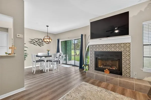 a living room with furniture a flat screen tv and a fireplace