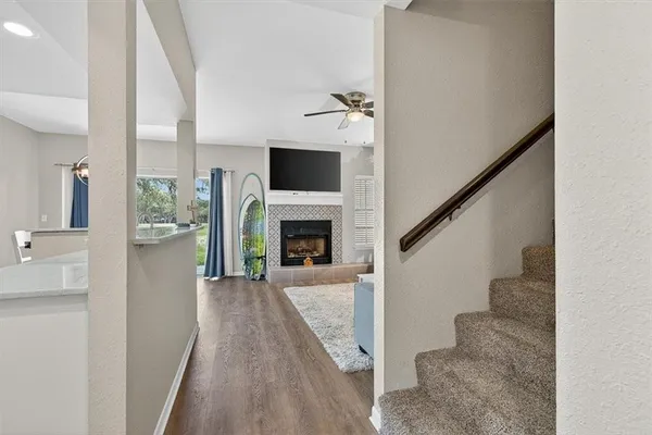 a view of a living room with furniture and a fireplace