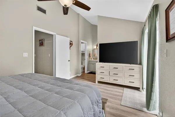 a bedroom with a bed and a chandelier