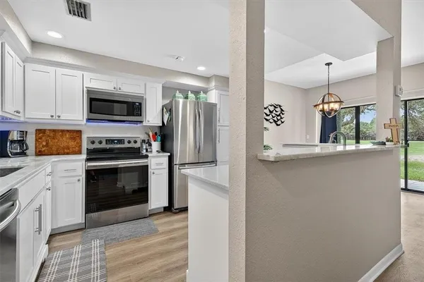 a kitchen with stainless steel appliances a refrigerator stove and microwave