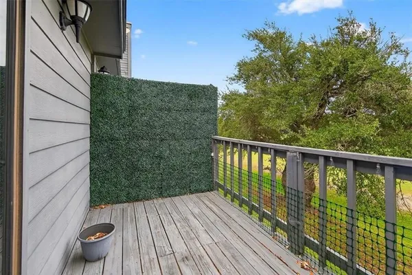 a view of balcony with deck and wooden floor