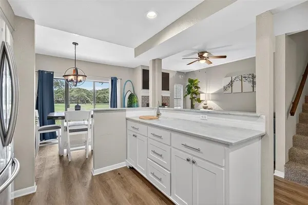 a kitchen with white cabinets and white appliances