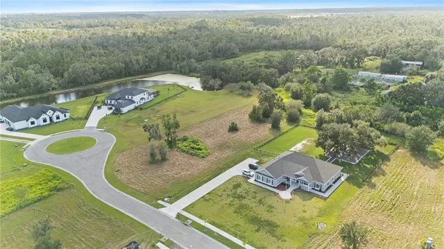 an aerial view of a house with a swimming pool