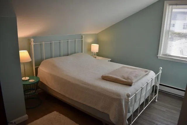 a bedroom with a bed and a lamp on table