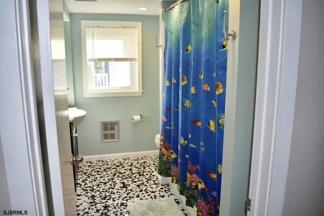 a bathroom with a toilet and a shower