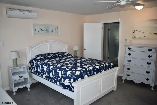 a bed sitting in a bedroom and dresser