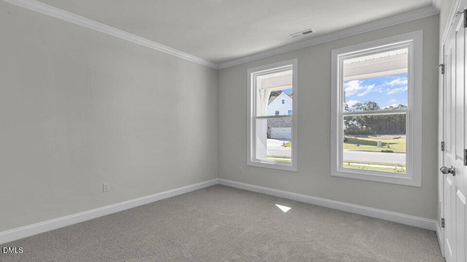 128 Gilmer Street Fuquay-Varina, NC 27526 - Photo 22 of 42 an empty room with windows