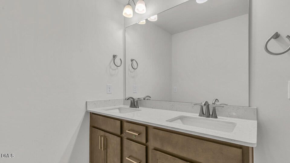 128 Gilmer Street Fuquay-Varina, NC 27526 - Photo 28 of 42 a bathroom with a sink and a mirror