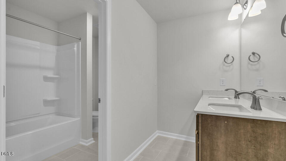 128 Gilmer Street Fuquay-Varina, NC 27526 - Photo 29 of 42 a bathroom with a sink and a mirror