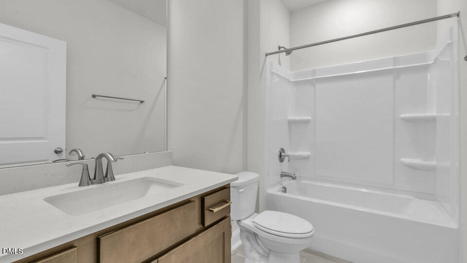 128 Gilmer Street Fuquay-Varina, NC 27526 - Photo 31 of 42 a bathroom with a sink toilet vanity and shower