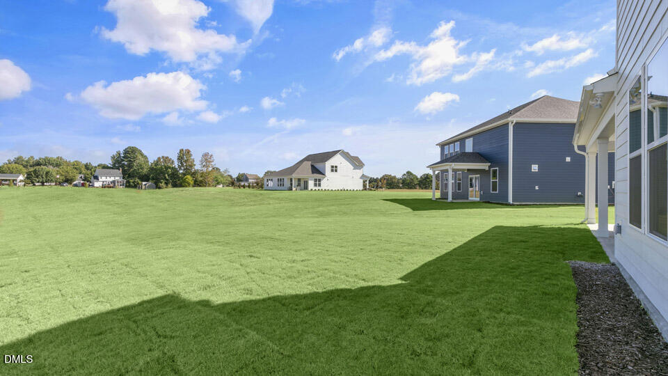 128 Gilmer Street Fuquay-Varina, NC 27526 - Photo 35 of 42 a front view of a house with garden