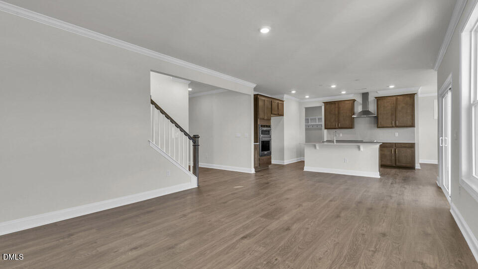 128 Gilmer Street Fuquay-Varina, NC 27526 - Photo 7 of 42 a view of a kitchen with a sink stove cabinets and empty room