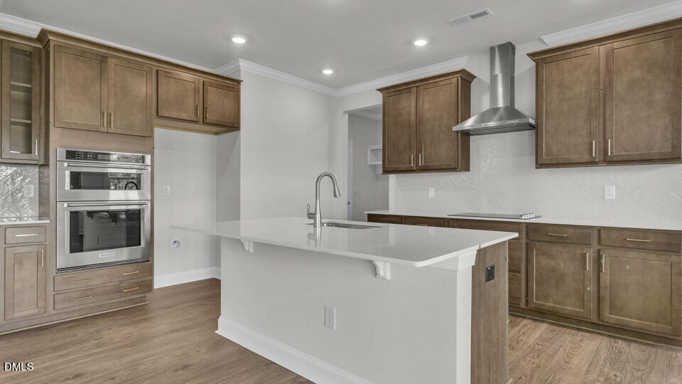 128 Gilmer Street Fuquay-Varina, NC 27526 - Photo 8 of 42 a kitchen with stainless steel appliances granite countertop a sink and a refrigerator